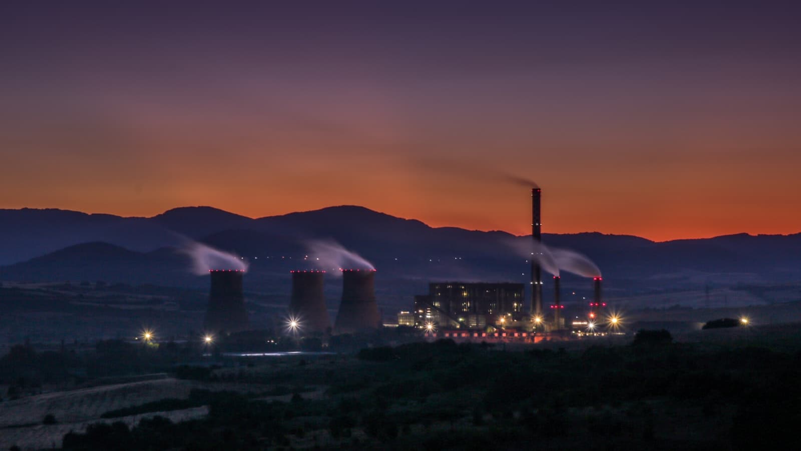Trucks on a highway at dusk, illustrating a modeled hours-of-service audit preparation.